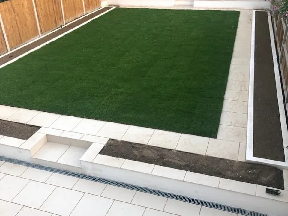 Artificial lawn and pale porcelain patio garden
