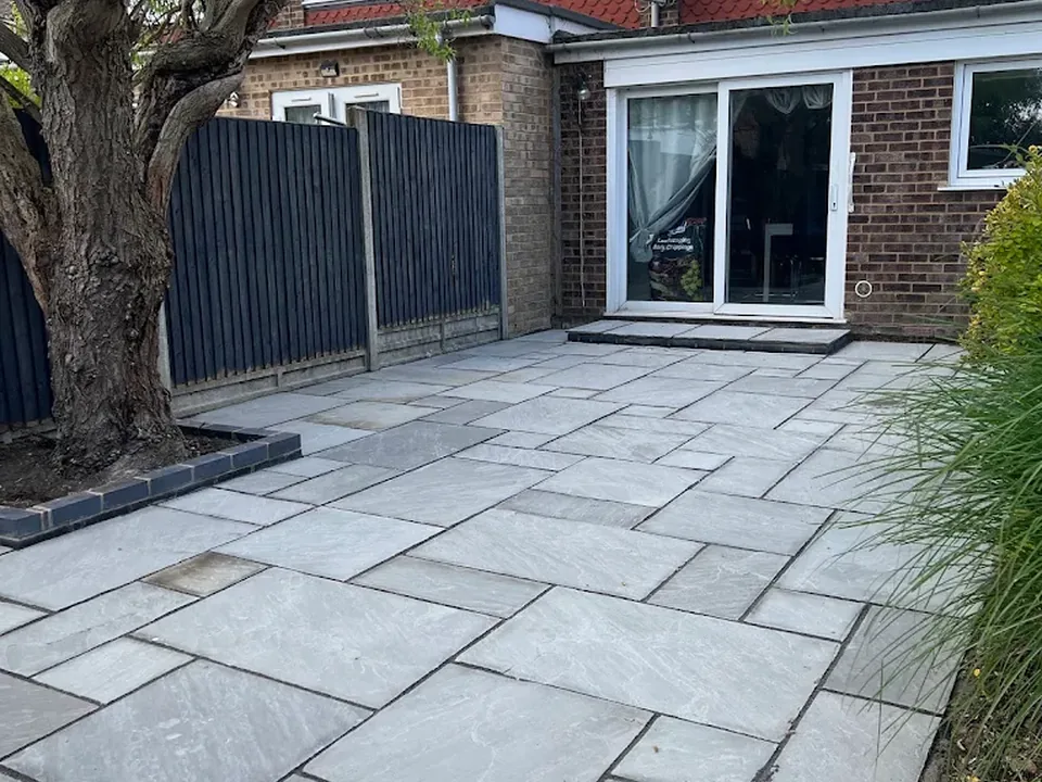 Grey porcelain-style patio beneath a mature tree